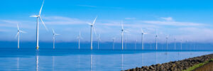 Windmills standing tall in the ocean